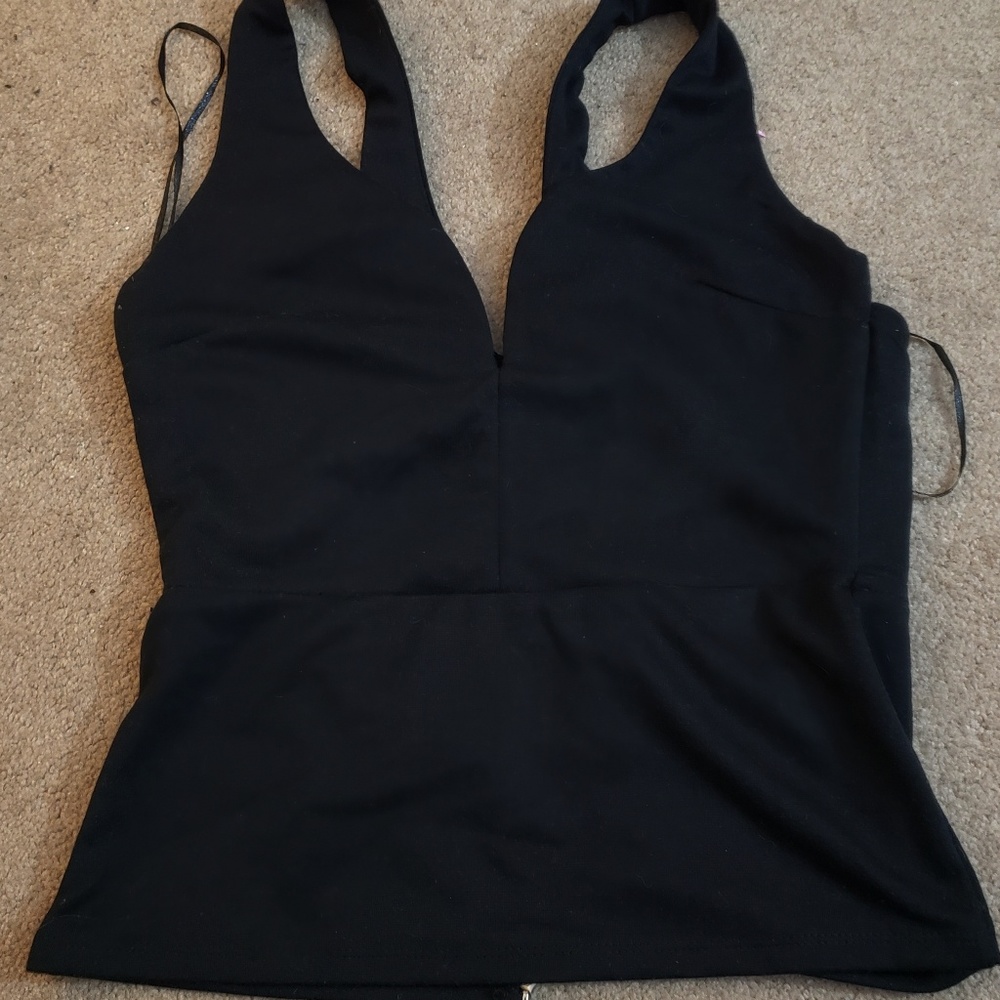 Black open back top has wire in cleavage part